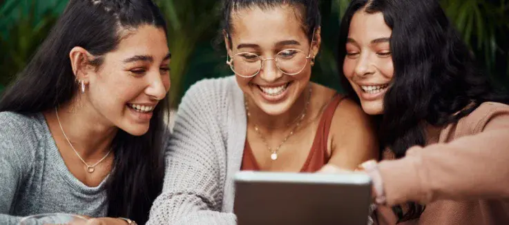 friends having fun looking at a phone