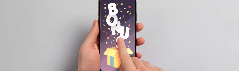 man holding a mobile phone with the word “bonus” 