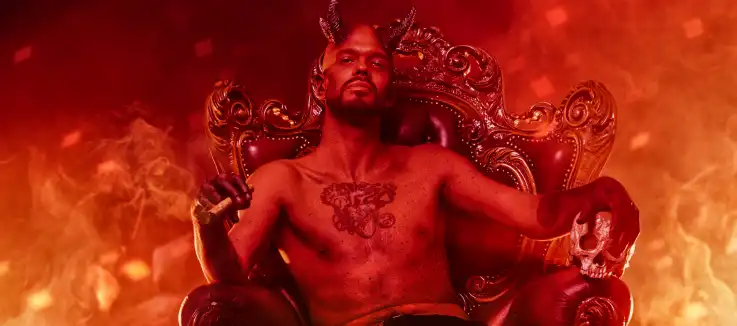 Hades smirkling while sitting on his thrown with fire all around