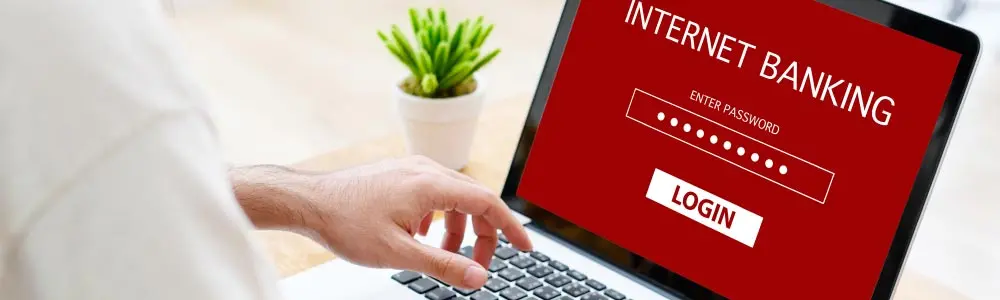 man on laptop logging into his online banking account