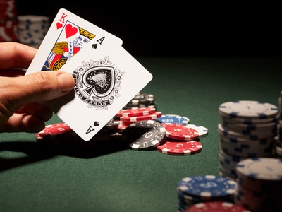 Blackjack hand with chips on the table in the background
