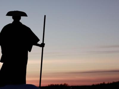 Chinese warrior silhouetted against a sunset