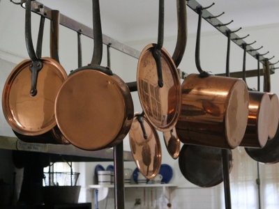 copper pots and pans hanging in the kitchen