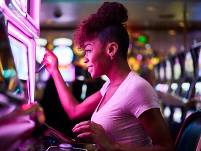 woman gambling at casino slot machine