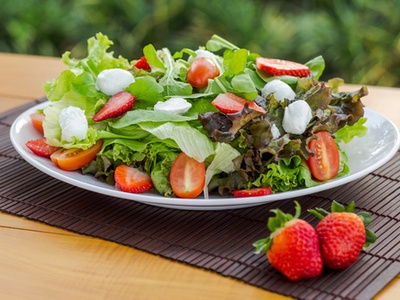 salad with green leaves, cheese and strawberries