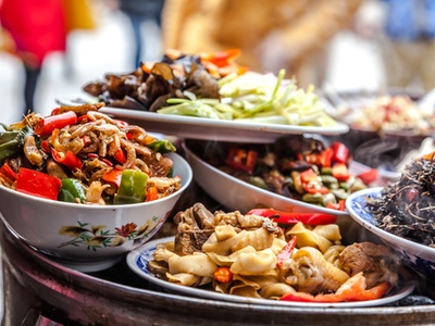 table piled high with food of different cuisines