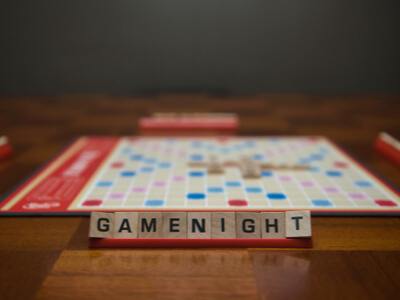 scrabble board on the table with GAMENIGHT letters on one stand