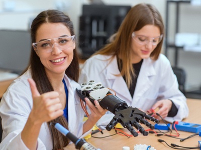 Young inventor working on a robotic hand 